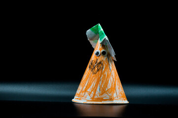 Paper cone characterized as a Halloween pumpkin