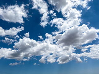 Blue sky with clouds, sunny day. White fluffy cloudscape, nature background