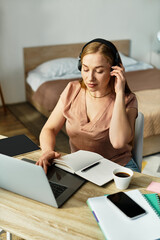Beautiful woman enjoying a cozy workspace while studying and sipping coffee at home