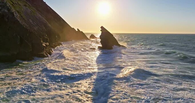 Aerial view of the cliffs of the famous Cabo da Roca are washed by the huge waves of the Atlantic Ocean at sunset - Powered by Adobe