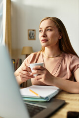 Young woman enjoying a cozy moment at home while sipping coffee