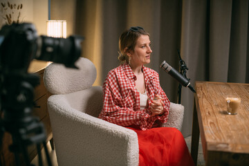 Video podcast recording studio. A conversation between a man and a woman sitting in front of...