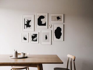 A minimalist gallery wall of small abstract prints placed on a table.