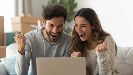 Young couple joyfully celebrates online shopping success during Cyber Monday in a bright and cozy setting