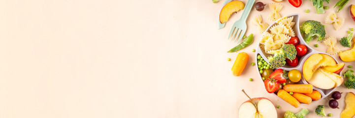 Baby finger food, various baby snacks, pasta, vegetables, fruits chopped for convenient, safe children's lunch, teaching small child to eat healthy food