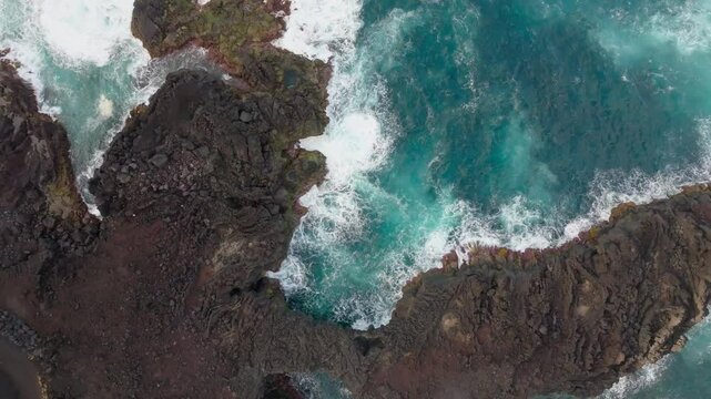 Aerial view of rocky coast and ocean waves, Portugal.