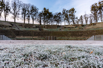Hoar frost on grass field in front of Roman theatre at Autun, France