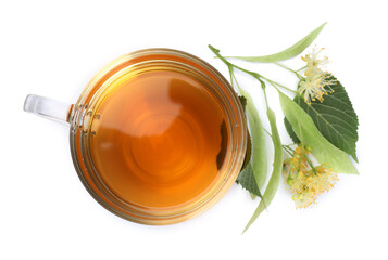 Tasty linden tea in cup, leaves and flowers isolated on white, top view