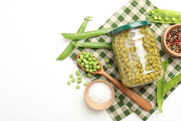 Tasty pickled peas in jar and ingredients on white table, flat lay. Space for text