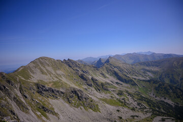 Breathtaking panorama of the High and West Tatras ridge, stretching under a clear blue sky and...