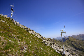 Automatic weather stations gathering meteorological data on a mountain ridge, contributing to...