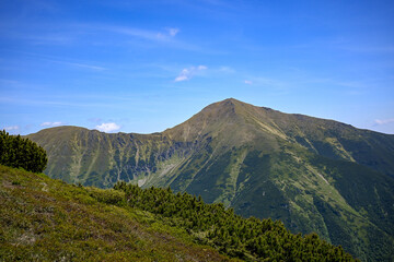 Breathtaking view of a prominent mountain peak towering over the lush green valleys of Baranec in...