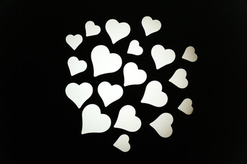 Colorful heart shapes create a vibrant display in a dark setting during a festive celebration