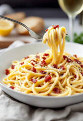 Pasta carbonara served in white ceramic bowl