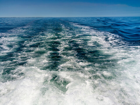 Seascape with water moved by the engines of a boat