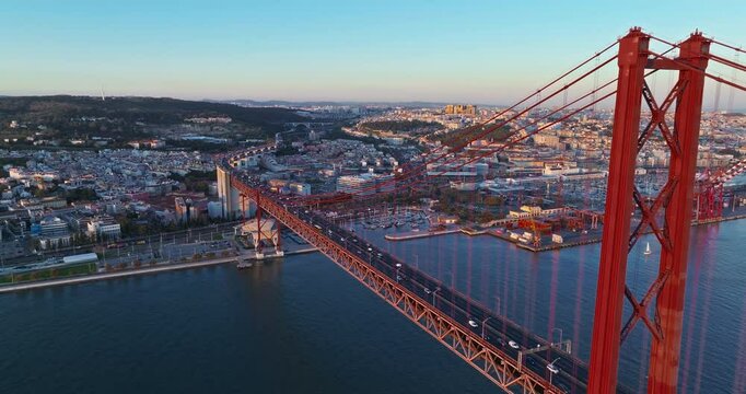 Aerial view of 25 de Abril bridge over the Tagus River at sunset in Lisbon, Portugal