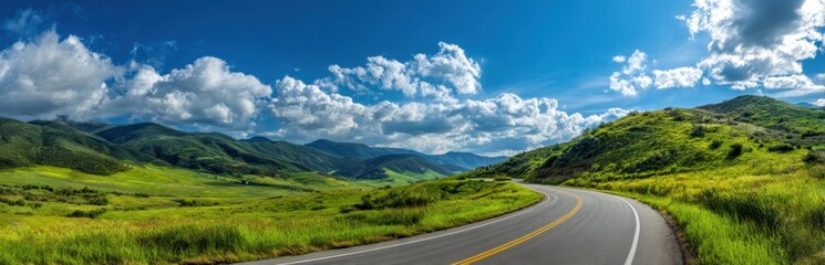 Winding road through vibrant green hills under a stunning blue sky, a picturesque summer journey.