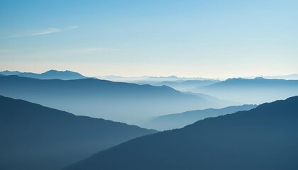Naklejka premium Misty blue mountain silhouettes in a wide horizontal panorama, design, backdrop