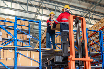 Warehouse worker working in warehouse storage. Foreman or worker work at factory site check up...