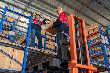 Warehouse worker working in warehouse storage. Foreman or worker work at factory site check up...