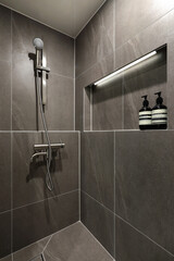 The interior bathroom with gray tiles is simple and stylish, and has a soft feel..jpg