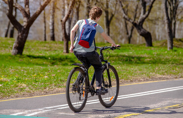 Cyclist ride on the bike path in the city Park
