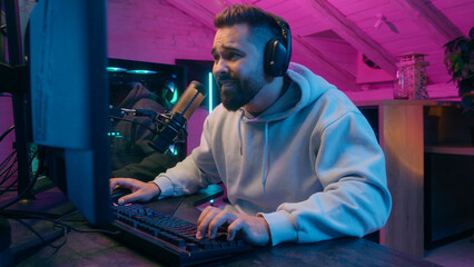 Smiling happy Caucasian addicted male gamer guy man streamer play at computer internet virtual...