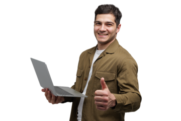 Cheerful young man gives a thumbs up while holding a laptop in a bright studio setting during a productive work session