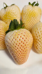Fresh white strawberries arranged plate showcasing unique textures