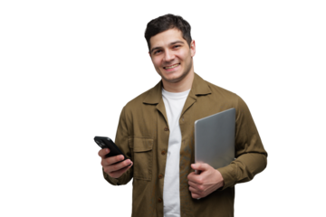 Young man smiles while holding a laptop and phone, ready for a productive day at work or school, embracing modern technology with enthusiasm