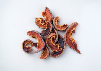 Several pieces of dry fruits on a white background. Healthy preserves dried fruits. A pile of dried...