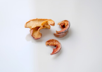 Several pieces of dry fruits on a white background. Healthy preserves dried fruits. A pile of dried fruit. Top view