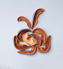 Several pieces of dry fruits on a white background. Healthy preserves dried fruits. A pile of dried fruit. Top view. Composition of pieces