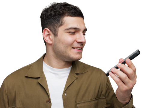 Smiling young man communicates joyfully with smartphone in a bright setting while engaged in a casual moment of connection
