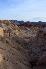 The mountain landscape in the desert is predominantly yellow before sunset