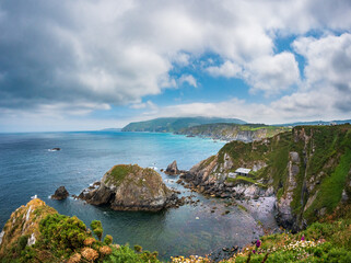 Spain Galicia coast near northernmost point of Spain rugged cliffs diving into turquoise Cantabrian...