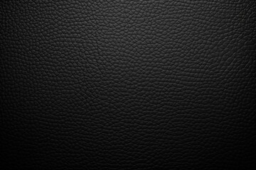 Obraz premium Close-up texture of black leather with detailed grain and natural patterns, showcasing a smooth yet slightly rugged surface.