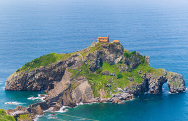 Gaztelugatxe Basque Country Spain stone path zigzagging up rocky island toward hilltop hermitage...
