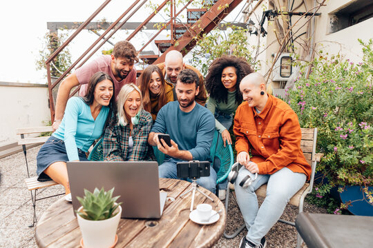 Group of diverse startup businesspeople having a video call on rooftop terrace
