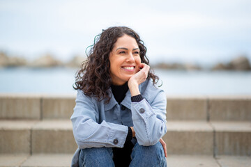 Smiling woman sitting on outdoor steps