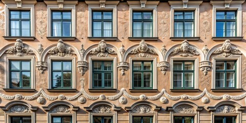Obraz premium Elegant Old Building Facade with Ornate Architectural Details and Dark Green Windows