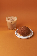 choux cream on a plate and coffee glass over beige background. Japanese Shu Cream