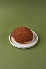 choux cream or Choux puff on a plate over green background. Japanese Shu Cream