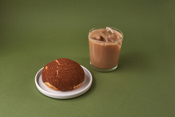choux cream on a plate and coffee glass over green background. Japanese Shu Cream