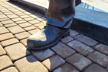 Close Up of Human Sculpture Feet and Shoes Capturing Intricate Details Artistic Expression.