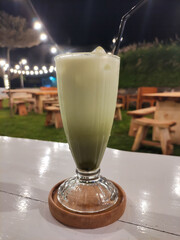 Refreshing Iced Matcha Drink Served at Outdoor Cafe at Night