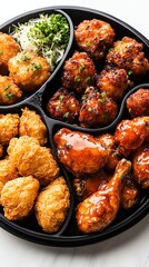 Korean fried chicken with spicy glaze on black plate