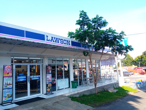 Bright image of a Lawson convenience store exterior, showcasing its entrance and signage under a clear blue sky. On September 27, 2024 in West Java, Indonesia.