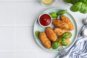 Tasty fried croquettes, basil and sauce on white tiled table, flat lay. Space for text