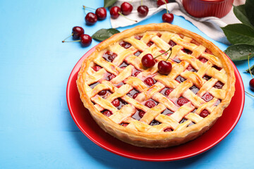 Tasty cherry pie on light blue wooden table, closeup